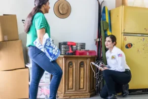 Jane, a Mister Sparky electrician in Tampa, inspecting a garage and consulting with a homeowner.